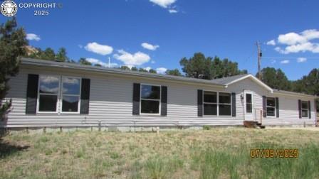 12855 County Road 255 Westcliffe, Colorado Welcome home to this beautiful 36-acre parcel located just at the Custer/Fremont County line on Oak Creek Grade. The landscape includes a variety of pine trees, pinions and rock outcroppings along with expansive views of the surrounding mountains. Situated nicely off the road and hidden behind the trees you will find a large, ranch-style manufactured home. Step inside to a roomy family room with the focal point being a corner rock fireplace. Desirable split bedroom design with a spacious primary suite that features not only a 5-piece bath, but a sitting room and a big walk-in closet. Sizeable kitchen with center island, stainless-steel appliances and dine-in area. Easy Care flooring throughout the home and even more areas to spread out in the sun filled family room. If that’s not enough enjoy the detached 2- car garage with extra space for a game room or hobby room. Additionally, you can find extra storage space for your recreational toys in the two storage sheds. This property has a lot to offer, don’t miss out.