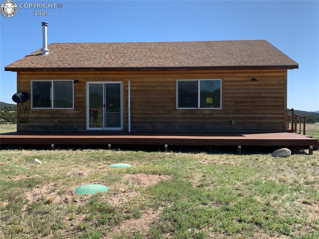1863 16th Trail Cotopaxi, Colorado Conveniently located just a short distance from S Path with expansive views of the Sangre De Cristo Mountains. What a great place to enjoy the gorgeous Colorado sunsets from the large deck stretching across the front of this home. Acreage is level and open with room for you to expand with a garage or storage sheds. Step inside this log-sided cabin to comfort and convenience. Open living and kitchen area with sun-filled windows. Laundry area tucked away in the kitchen pantry. Pellet stove for additional heat and a mini-split to help keep things cool too! Primary bedroom features it's own bathroom with double vanity and step-in shower. Easy access to Canon City or Westcliffe, don't miss out on this one!
