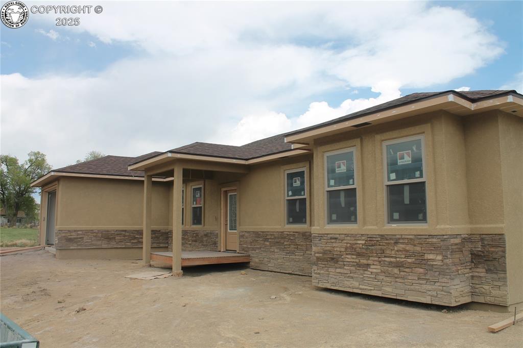 1140 Illinois Avenue Canon City, Colorado Absolutely incredible brand new build in North Canon City on a nearly one acre lot. The builders are known for their incredible attention to detail. This house stuns as you enter through the front door you are invited to an open living concept with living area, dining area and kitchen all carefully crafted and laid out to ensure that you have every convenience. The kitchen area boasts a large island area covered with beautiful granite, and a second sink, which is surrounded by custom cabinetry, granite counter tops, and lots of area to move around. Adjoining the kitchen is an area for a large family gathering table and the immense area dedicated to a family living area. Step out through the doors of the great room to an enormous covered patio area that features spectacular views of mountain vistas in the distance. Peace and tranquility will envelop you where you can enjoy the evening sunset or morning sunrise. There are 4 bedrooms and 2 1/2 baths. The split bedroom design allows for the main bedroom on one side with a beautiful and large master bath getaway. The other three bedrooms are situated to the other side of the home with a large main bath area and a second 1/2 bath for guests and secondary use of the bedrooms. Large completely finished 3 car garage. Upgraded Anderson windows throughout the home. The laundry room boast hot water on demand, lots of additional storage, granite counter tops and a sink. The property allows horses or continue to grow the hay/grass field and use for passive income from the 2 shares of Canon Heights ditch that provide irrigation to the property. If you are looking for a great property in a semi rural area with quick access to the amenities of Canon City this is the place for you. The home is approximately 2 months from completion. Expected date of completion is July 1, 2025.