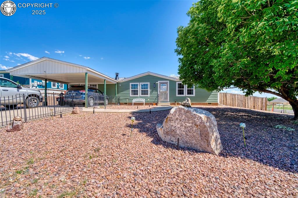206 Indian Hills Road Florence, Colorado It's time to schedule your tour of this extremely well maintained home home situated on corner lot just outside of Florence, Colorado (home to the area's Antique Capital). This home is truly Move-in ready! Even the wall mounted TV's are included in the purchase! Home has a low maintenance xeriscaped fenced front yard with a large shade tree. Large carport provides covered parking for at least 2 vehicles plus on street parking in the front and side of home. This home has the huge benefit of a double corner lot (that's nearly an half acre!) with an amazing view of Pikes Peak from the 10x40 covered back deck. Entire back yard is fully fenced with a wood privacy fence, raised garden beds (with easy watering system already in place). Solar panel/system are included which reportedly reduce the monthly electric bill to about $10/month with an assumable loan for a little over $118/month. There's also a well built 12x24 shed in the backyard to store all the extra things, including the Husqvarna riding mower which is included. (How thoughtful is That!) Inside you will enjoy the large living room with a fireplace and big dining area adjacent to the kitchen for a comfortable dining experience while enjoying your mountain views and city lights at night. Split bedroom floor plan provides additional privacy with a large master bedroom with a 5 piece attached bathroom and convenient walk in closet. Additional pluses go beyond the solar panels add the new roof(transferrable warranty) and upgraded siding completed in December 2024 along with a recently purchased multiple camera security system with audio and video capabilities is also included. Schedule a tour and Discover your new home!