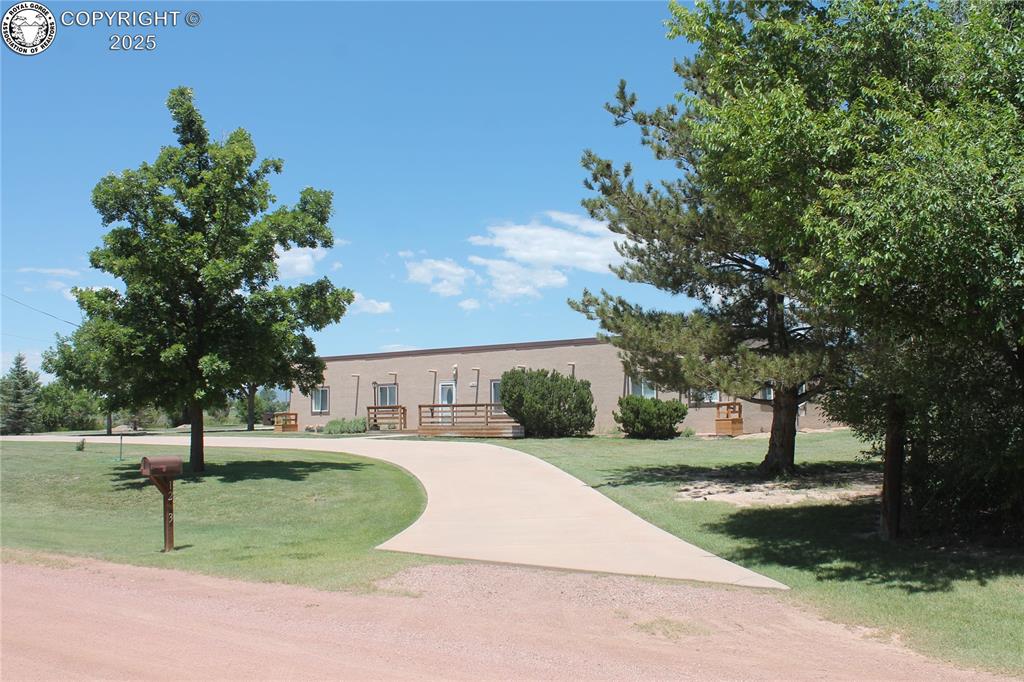 1263 13th Street Penrose, Colorado Spectacular and immacuately maintained 4 bedroom 2 bath 3200 square foot home on 4.41 acres of natural beauty surrounding this great home. The open concept living area greets you as you walk through the front door. The kitchen, living room and dining area flow seamlessly and provide a warm and inviting common area of the home. An additional large family room with access to a back deck provides a secondary living environment. This property is surrounded by mature trees, a large hay field (which is maintained by a local farmer) a 2 car garage, shop area with additional parking available for the RV, riding mower, etc and another building that can serve as a craft get away, garden shed, etc. This home has been meticulously cared for inside and out. The concrete circular driveway surrounds the home with additional concrete driveway to the garage and outbuilding. RV pad site. There are 2 full bathrooms, the main bathroom is reminiscent of a spa getaway. Large rainfall shower and beautiful accents throughout. The laundry room separate and also serves as a large pantry area behind the wash room. The back yard area offers a covered area, BBQ nook and peace and tranquility. The 360 degree views from this property are immaculate and breathtaking. Look to the South and gaze at the wet mountain range, look to the North and you are looking at the front range and Pikes Peak. Many an evening can be spent enjoying the beautiful surroundings. Raised bed garden area between the outbuildings. 7 zone sprinkler system, with several frost free ports on the property keep the trees, flowers and shrubs looking beautiful. 5 shares of Beaver Park water. Please view the link for the virtual tour and drone video of the property.