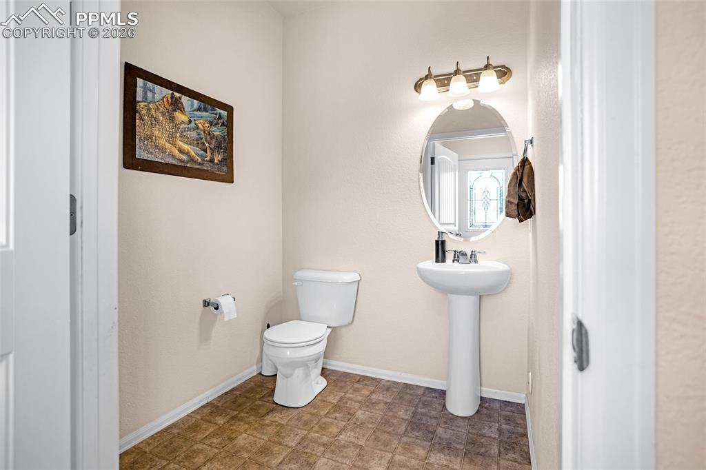 Bathroom featuring toilet and baseboards