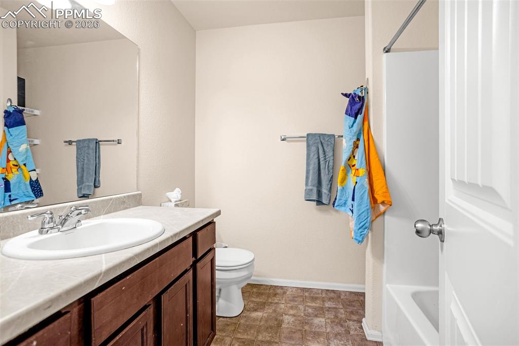 Full bathroom with vanity and toilet