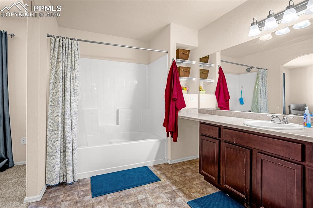 Bathroom with vanity and shower / bath combination with curtain