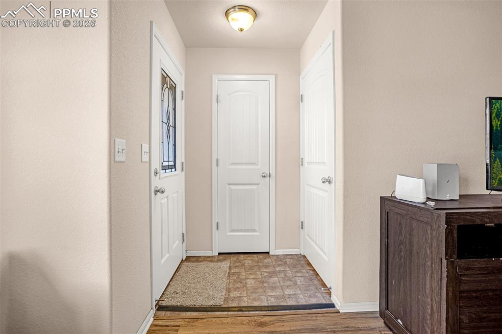 Entryway featuring baseboards and light wood-type flooring