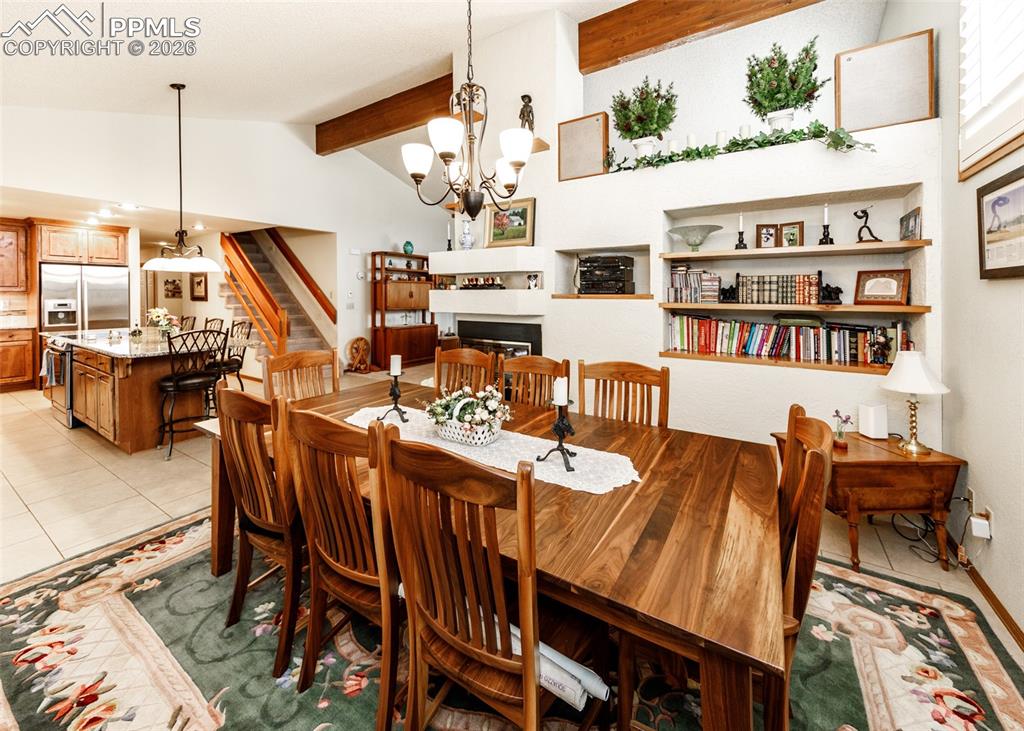 This custom designed dining area features built-in cabinetry, offering stylish storage and presentation, and is filled with ample daylight, which elevates the light and friendly atmosphere. A comfortable, functional gas fireplace provides a touch of warmth and refinement, and the smooth connection to the adjoining family room establishes a truly open and charming setting, ideal for relaxed get-togethers and special occasions.