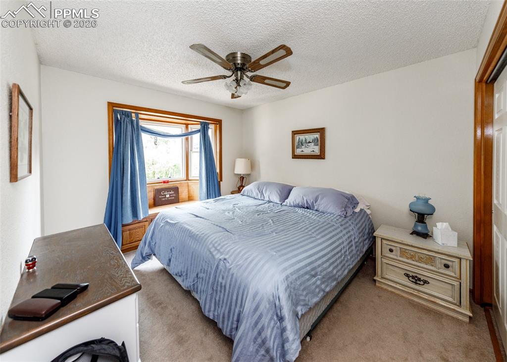 Main floor bedroom featuring a spacious closet and a charming bay window, providing ample natural light and a comfortable ambiance.