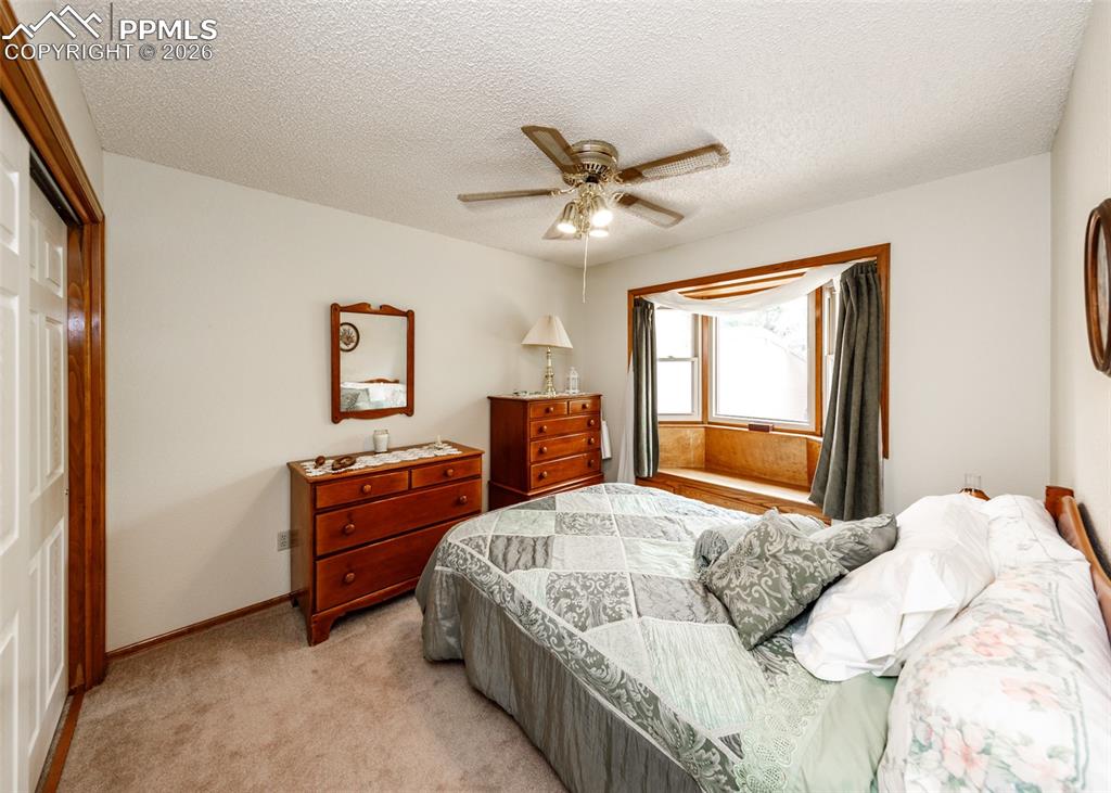 Main floor bedroom featuring a spacious closet and a charming bay window, providing ample natural light and a comfortable ambiance.