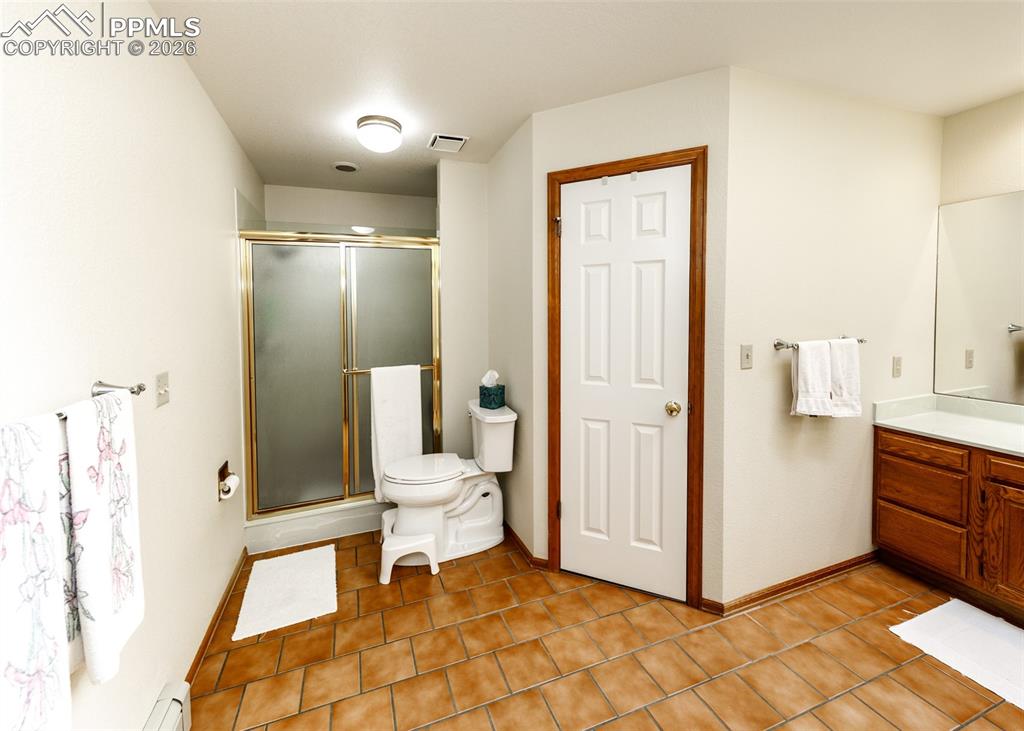 Master bathroom featuring a walk-in closet with dual vanity sinks. Comfortable and spacious.