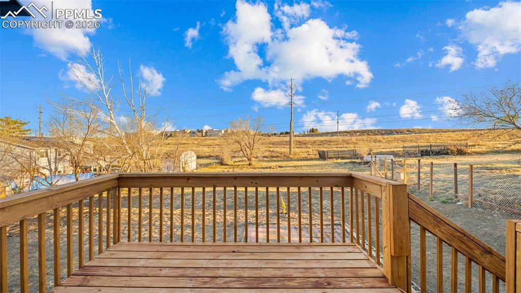 Yard extends all the way back to the electrical poll past the fence