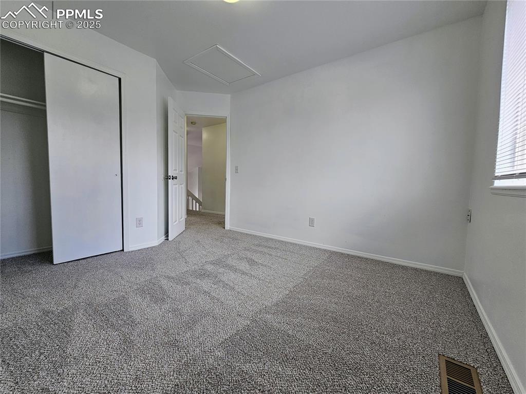 Unfurnished bedroom with carpet and a closet