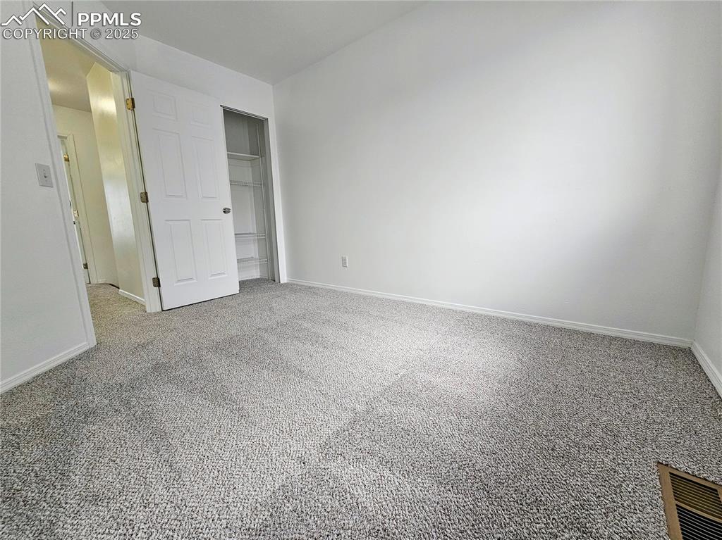 Unfurnished bedroom featuring carpet flooring and a closet