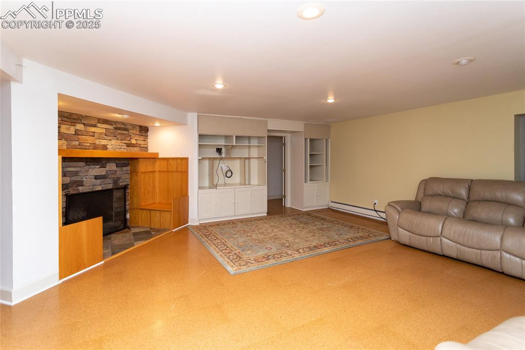 Basement living room with fireplace and couch