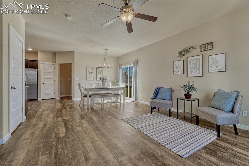 Living room features high ceilings and plank floor