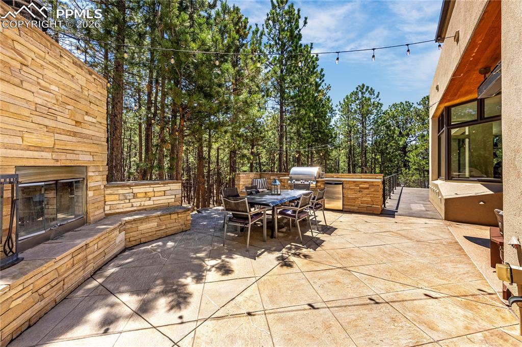 Side patio with built-in grill & fireplace