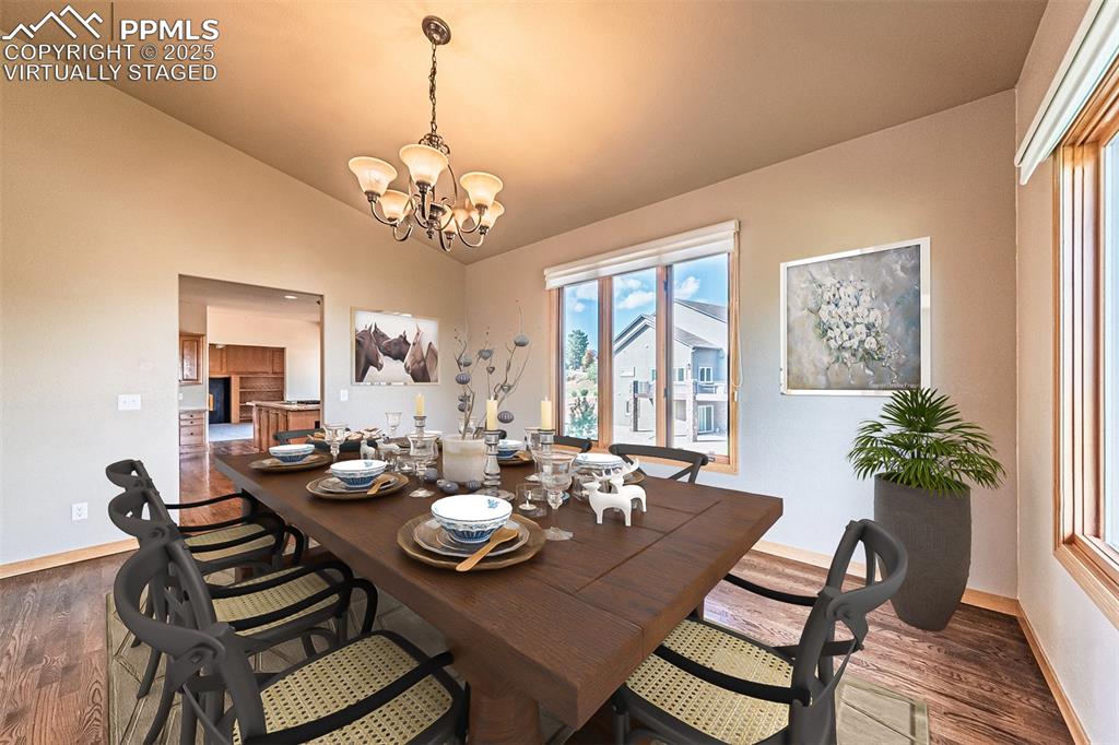 Virtually Staged
Dining room with dark wood finished floors, vaulted ceilings.