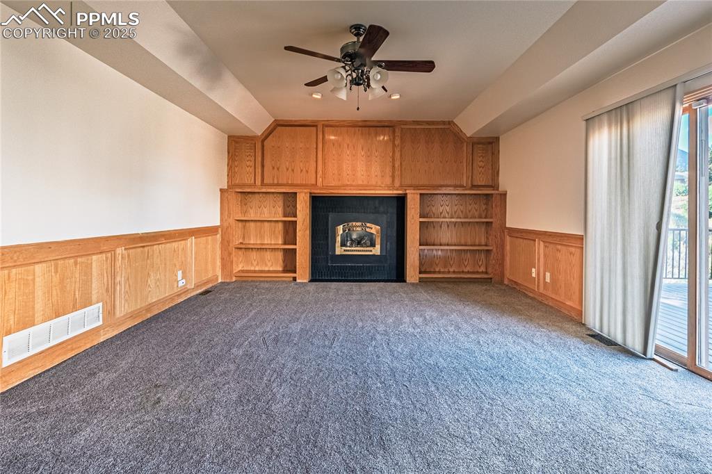 Unfurnished family room with fireplace.
