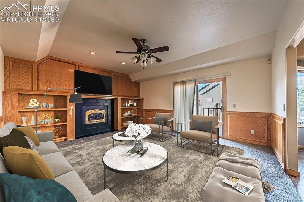 Virtually Staged
Family room with wainscoting, a fireplace, wood walls, carpet, and natural light