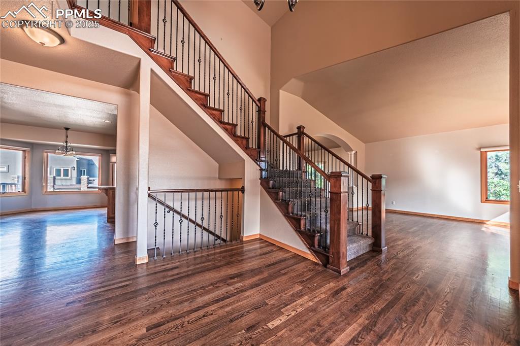 Welcoming entryway with hardwood flooring and a
decorative light fixture, leading into the main living areas.