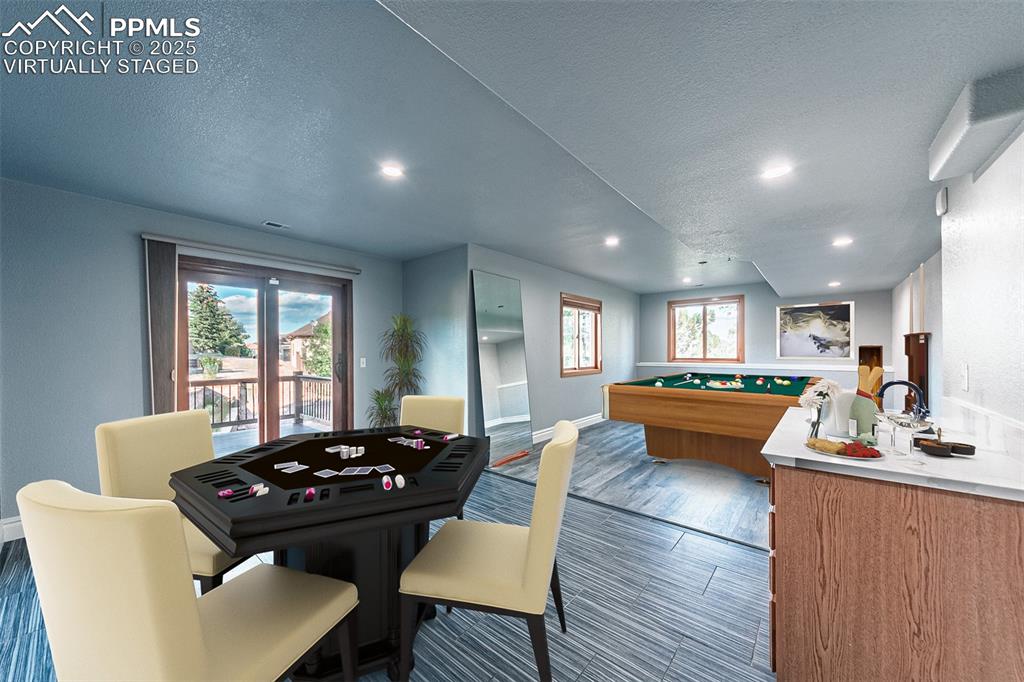 Virtually Staged
Game room featuring dark wood-type flooring, a textured ceiling, and recessed lighting