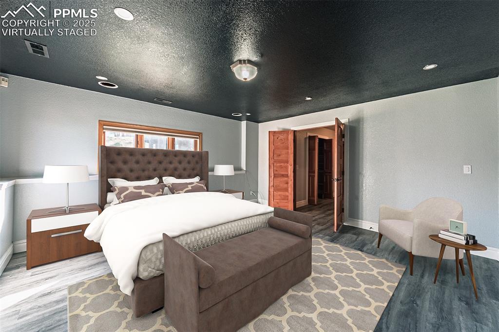 Virtually Staged
Bedroom featuring wood finished floors, a textured wall, recessed lighting, and a textured ceiling