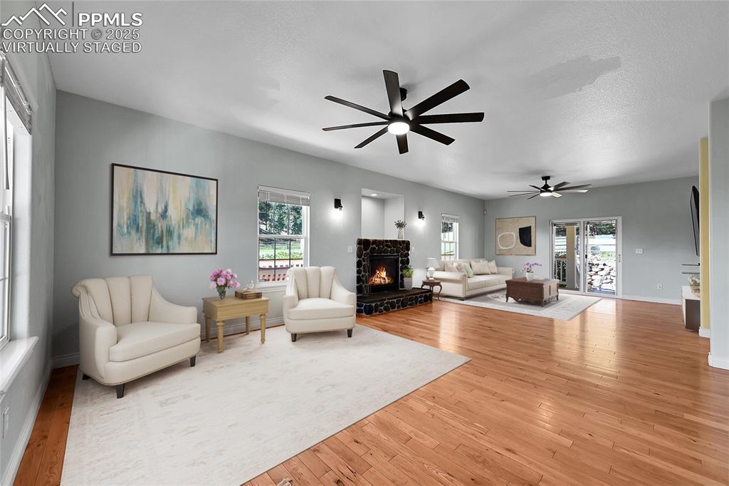 Virtually staged -spacious living room featuring fireplace and walkout to back patio