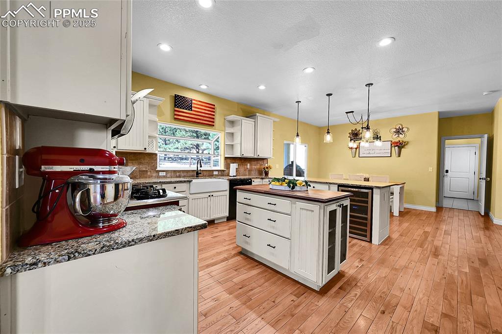 kitchen island, farm style sink, wine fridge, breakfast bar, pantry