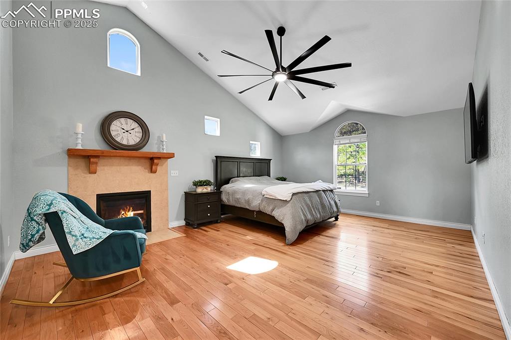 Primary bedroom featuring sitting area with fireplace