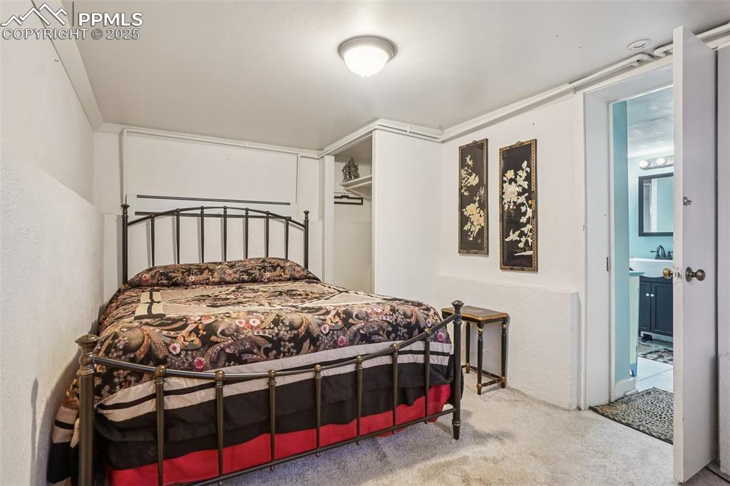 Bedroom on the lower level with private entry/exit to yard and covered parking