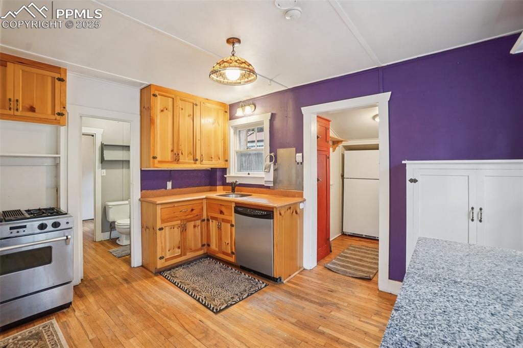 Kitchen with gas stove, plenty of cabinet space, movable island and wood flooring