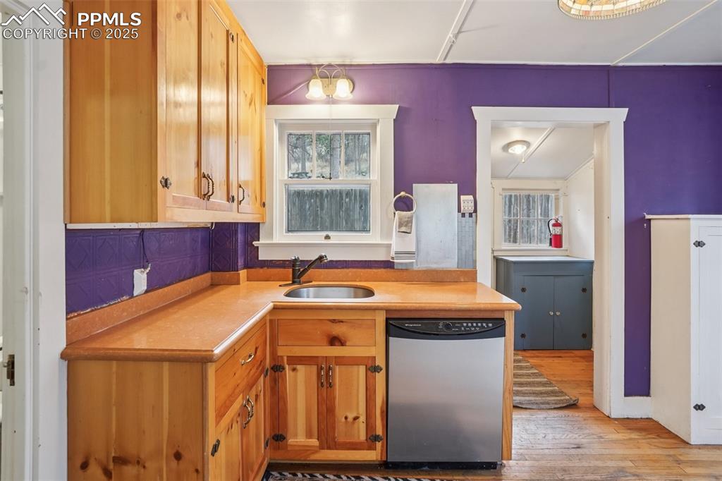 Kitchen with gas stove, plenty of cabinet space, movable island and wood flooring