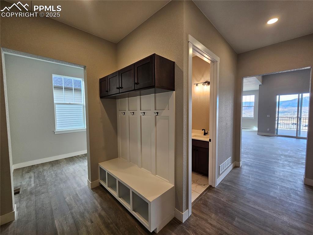 Mudroom with dark wood finished floors