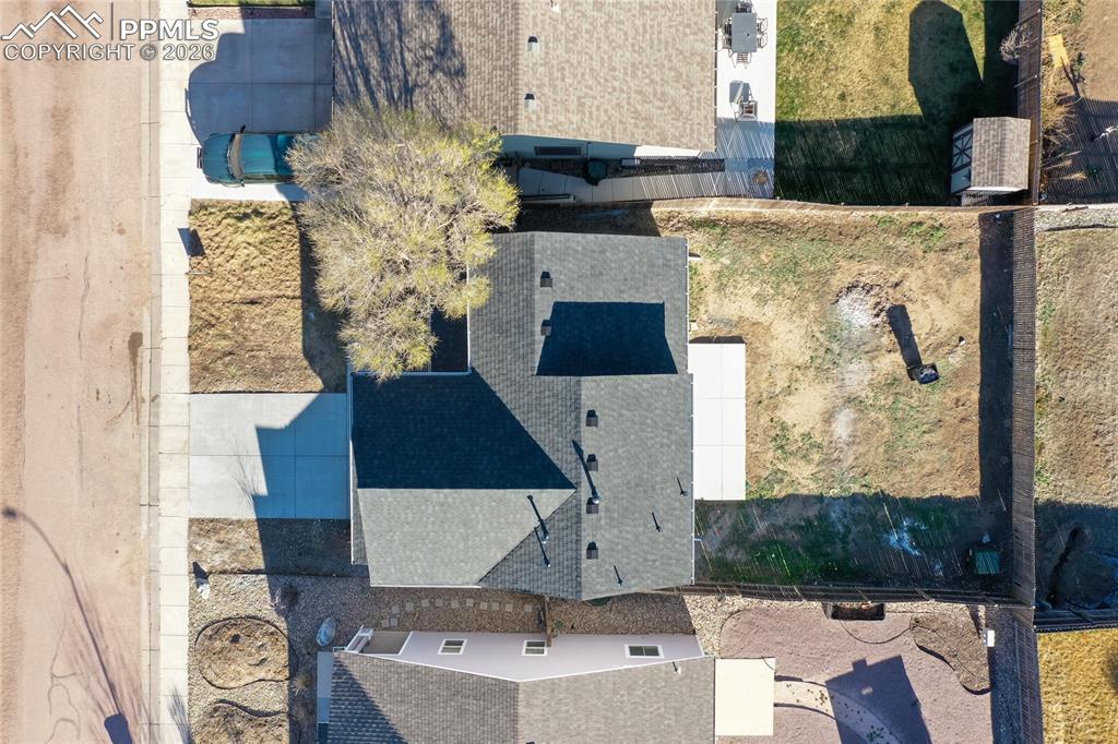 Shows the new roof, new driveway, new patio and large fenced.