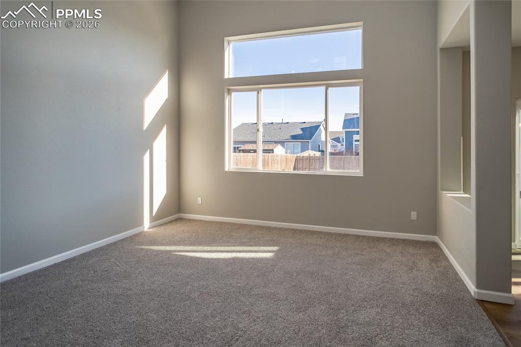 the 2 story living room is flooded with light.