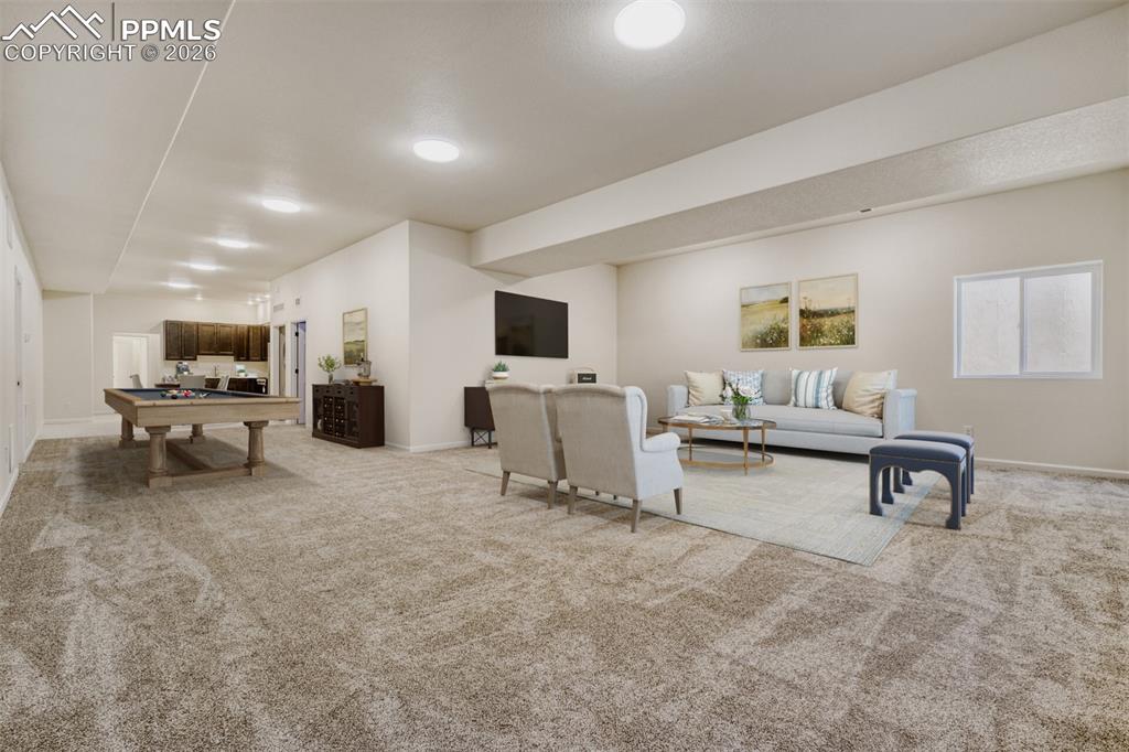 Virtually stage d basement family/game room with kitchenette and second laundry