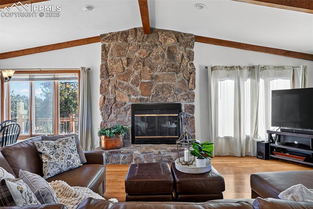 Wow!  Beautiful full height stone fireplace and beamed ceiling!  