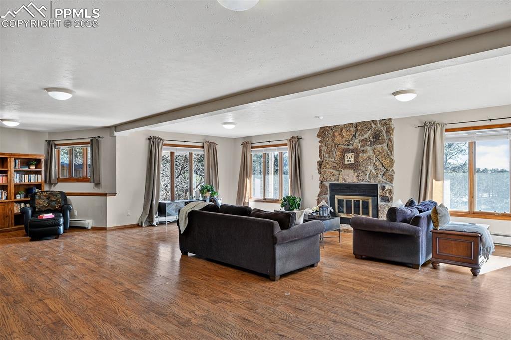 Another view of this large and yet cozy basement with another stone fireplace!