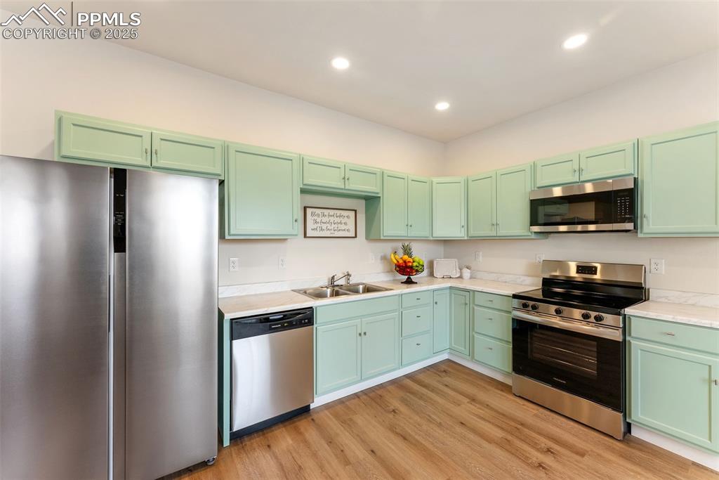 Light but still warm colored cabinets and quartz countertops