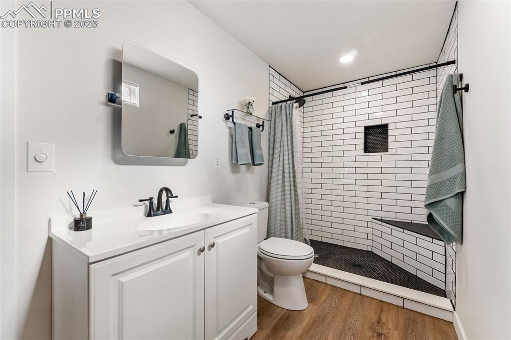 Remodeled 3/4 bath with a walk-in shower with floor to ceiling tile surround