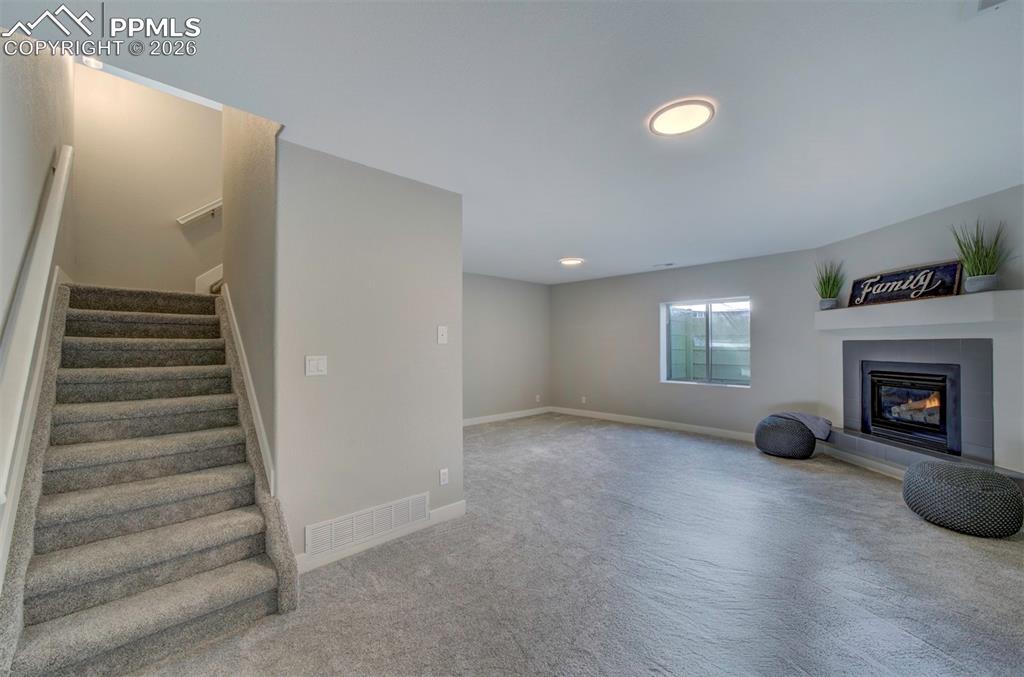 Brand new carpet down here w/ an updated fireplace