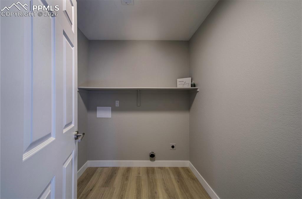 Laundry in the basement with shelving