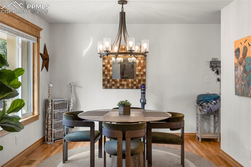 Formal dining room, hardwood flooring and large picture window. 