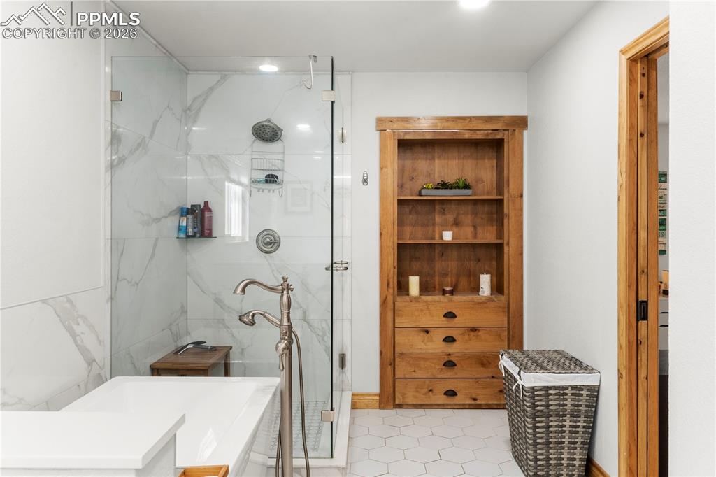 Attached and fully updated full bath with free standing shower and large soaking tub. There is a large walk-in closet behind the bookshelf that opens.