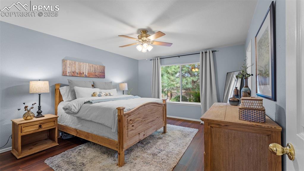 Bedroom featuring dark wood-style floors and ceiling fan