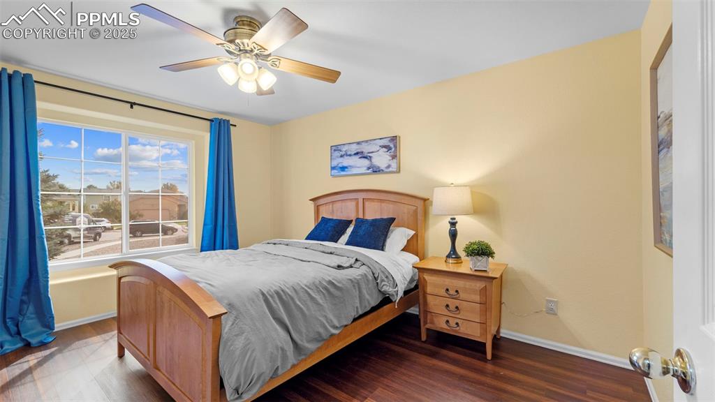 Bedroom with wood finished floors and a ceiling fan