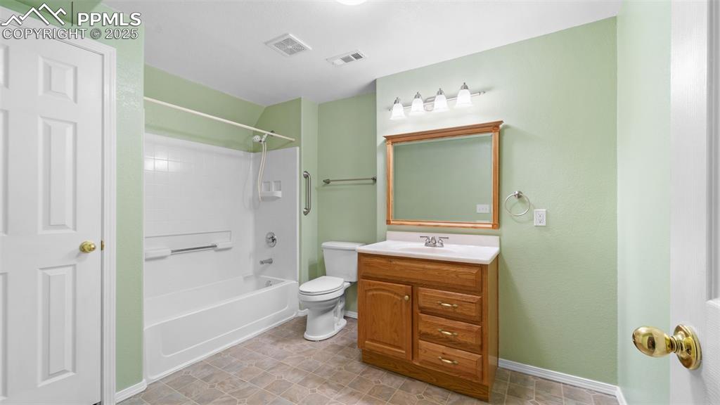Bathroom featuring shower / tub combination and vanity
