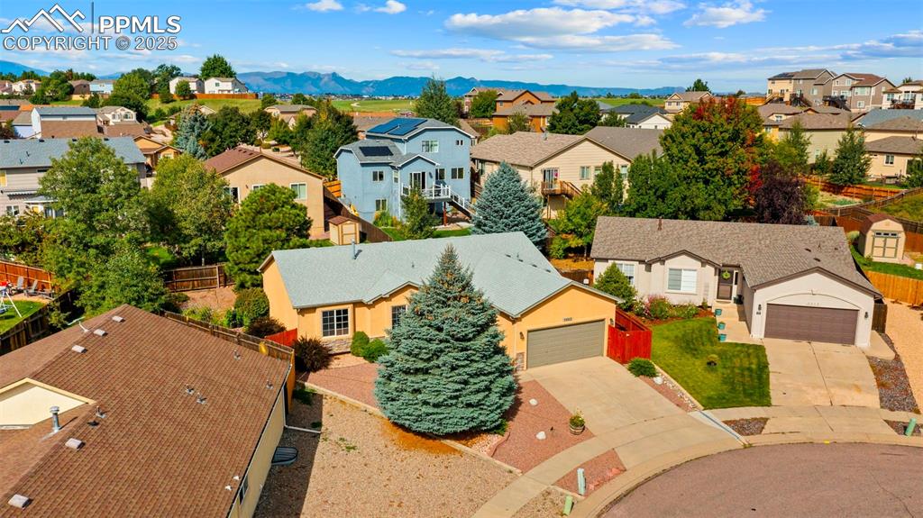 Aerial view of residential area featuring mountains