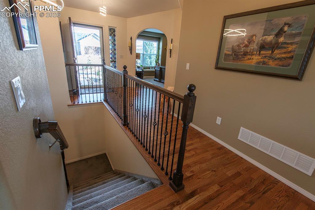 Front door and office on left, hallway for stairs to basement