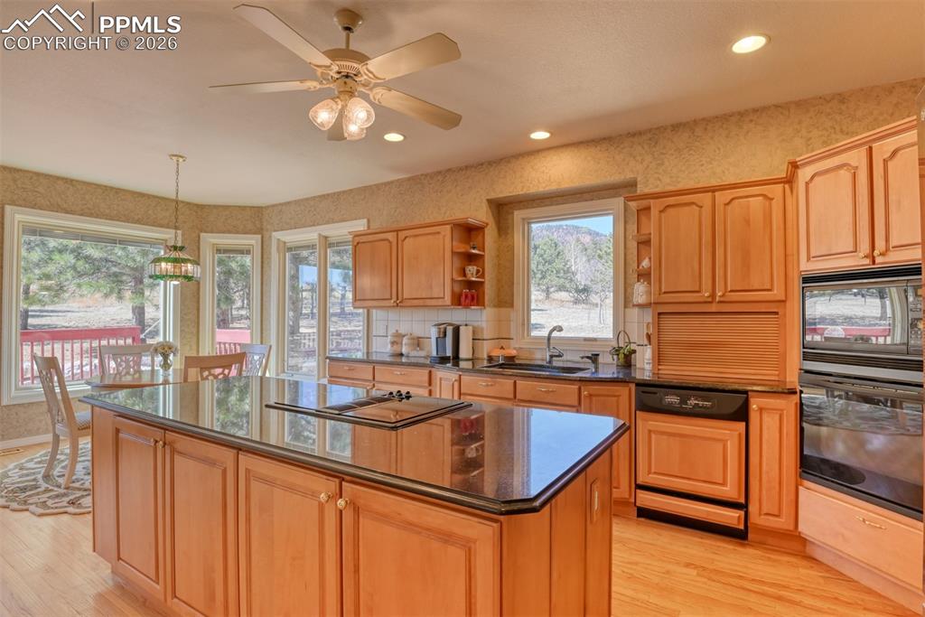 Kitchen is light and bright and has spacious island, lots of storage in the island, and granite countertops. 