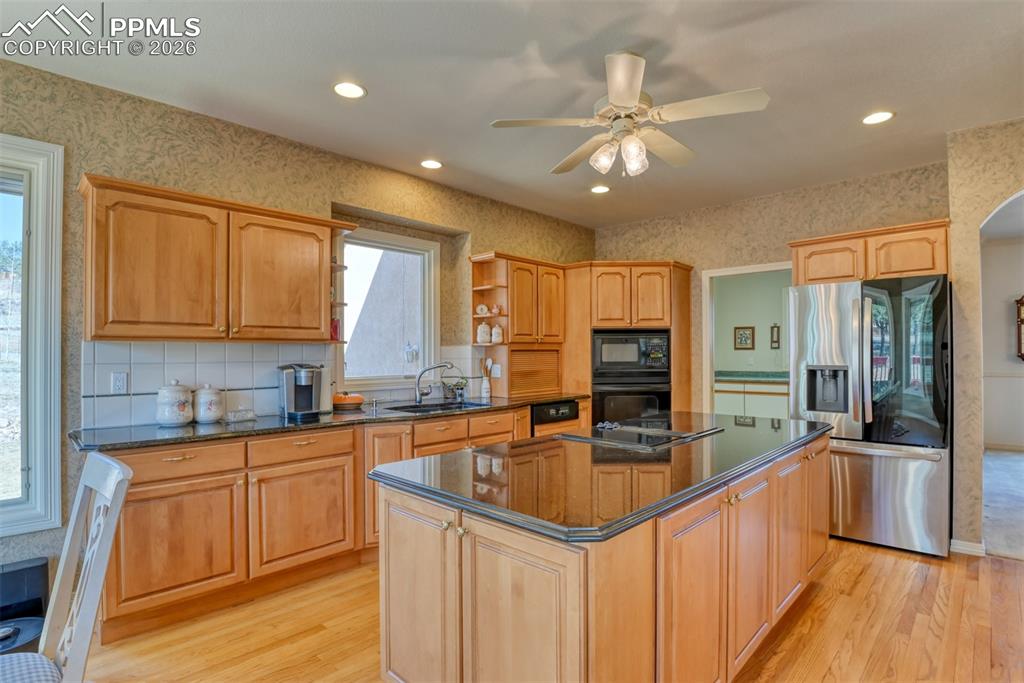 Laundry room is connected to the laundry room. Notice the storage cabinet at the end and front of the island. Newer stainless steel refrigerator 